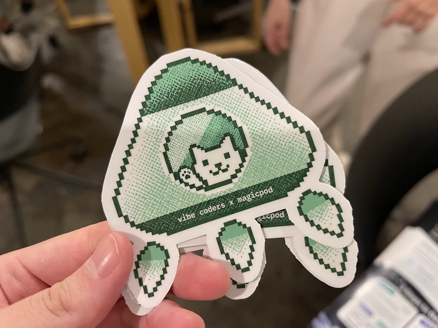 Original pixel-art sticker designed for Vibe Coders Tokyo × MagicPod, featuring a cat inside an onigiri-shaped rocket